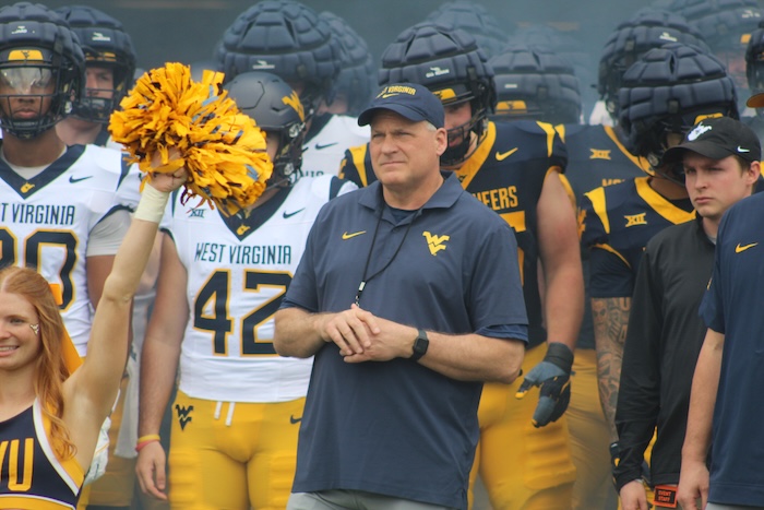 WVU Football HC Rich Rodriguez in front of team