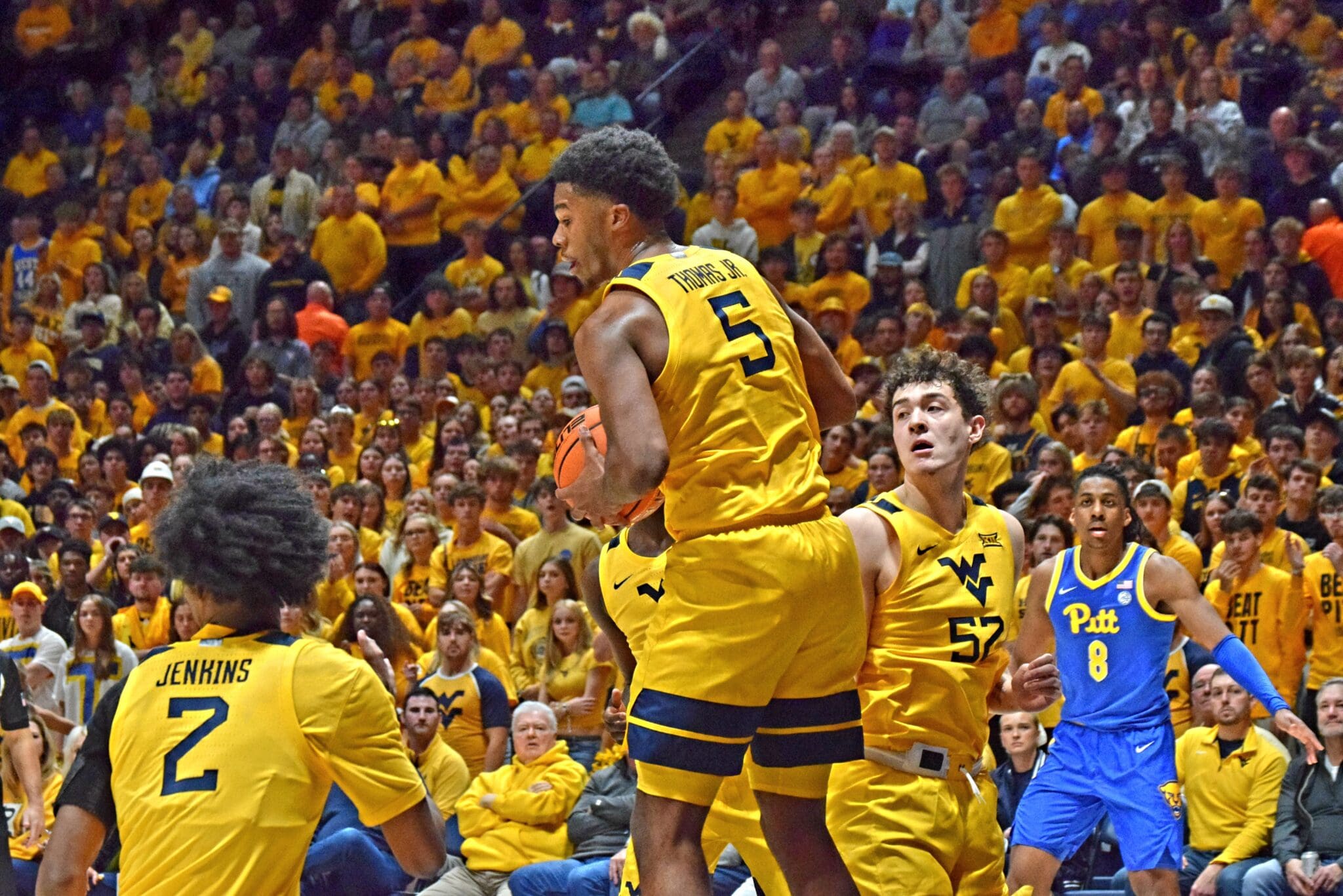 WVU Basketball players and crowd in Backyard Brawl