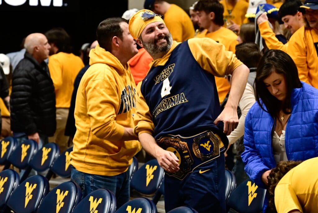WVU fan with title belt