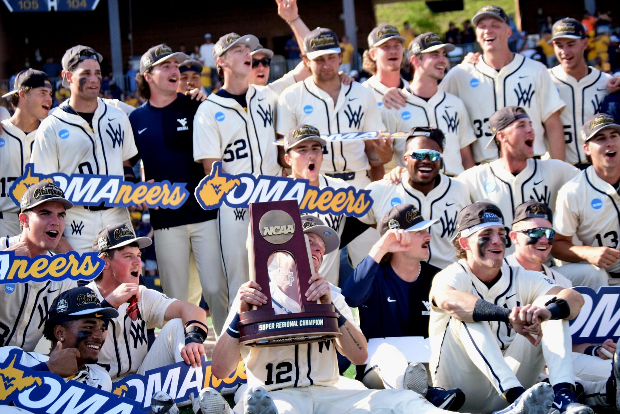 WVU Baseball players celebrate with Super Regional trophy