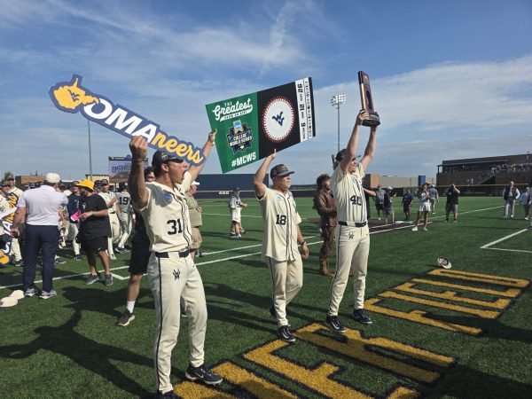 WVU Baseball players with sign and trophy