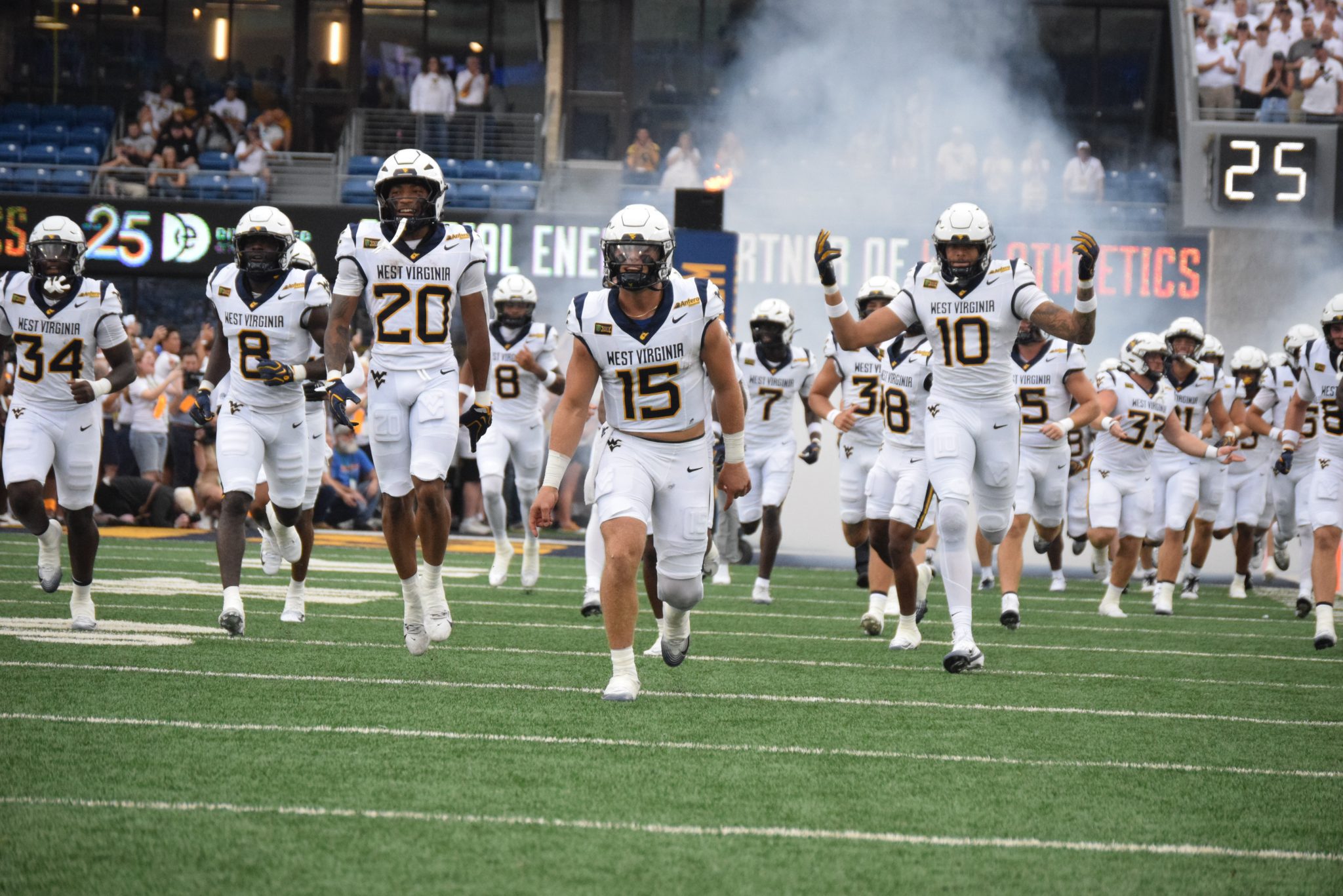 WVU Football players running on field